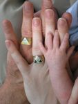 Image of three hands - dad, mom & baby